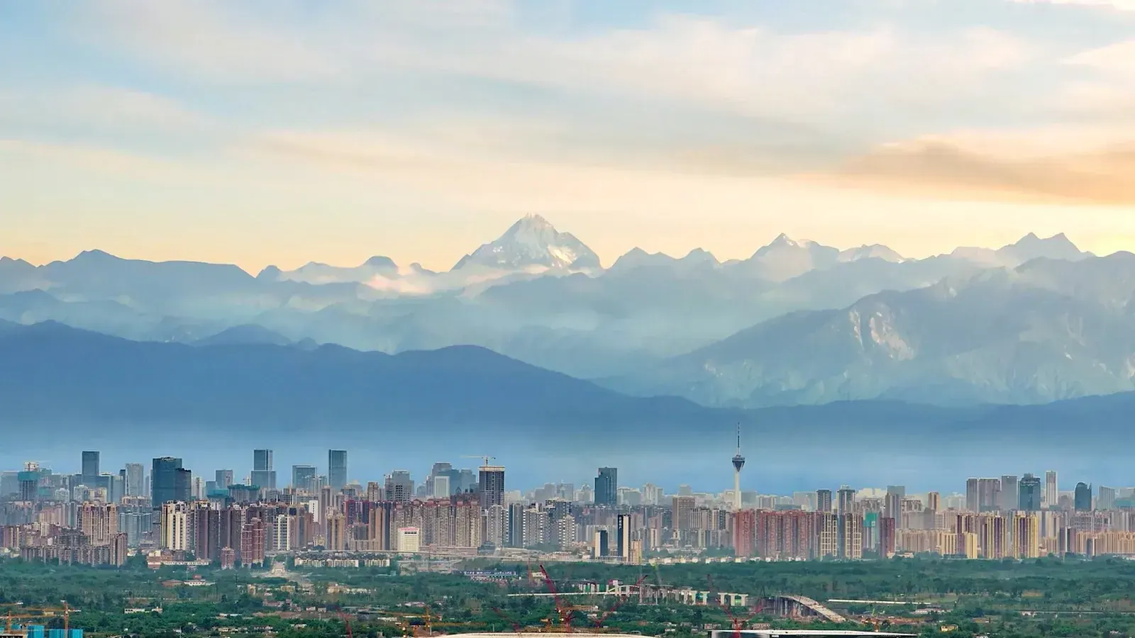 Chengdu’s skyline beneath the snow peaks of the western rim